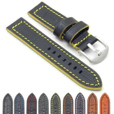 A black leather watch strap with yellow stitching and a silver buckle, accompanied by various colored leather straps displayed below