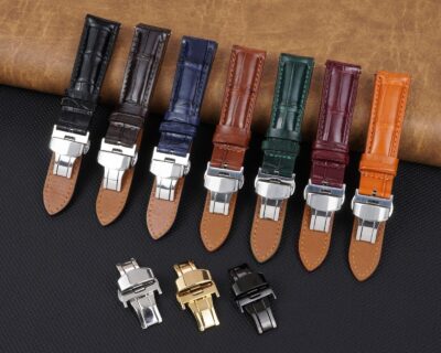 A variety of watch straps in different colors and materials, showcasing various clasps and buckles, arranged neatly on a textured surface