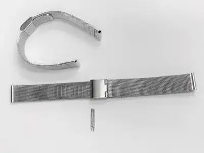 A silver mesh watch strap laid flat with a clasp and a pin for attachment, showcasing its clean and modern design. Ideal for maintenance and care tips