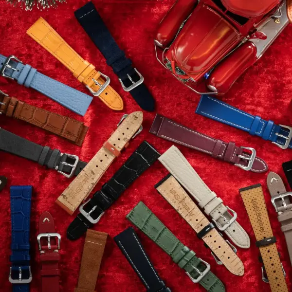 A vibrant assortment of watch straps in various colors and materials arranged on a festive red background, perfect for any holiday occasion