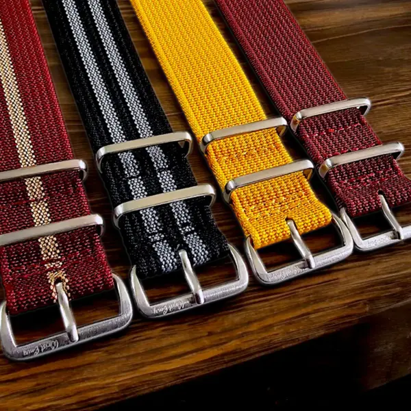 A collection of nylon straps in various colors, featuring metal buckles, displayed on a wooden surface, showcasing their versatility for smartwatches