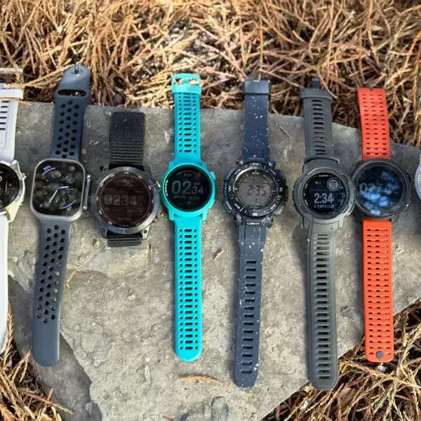 A variety of smartwatch straps displayed on a rock, showcasing different colors and styles, ideal for selecting the right strap for hiking adventures