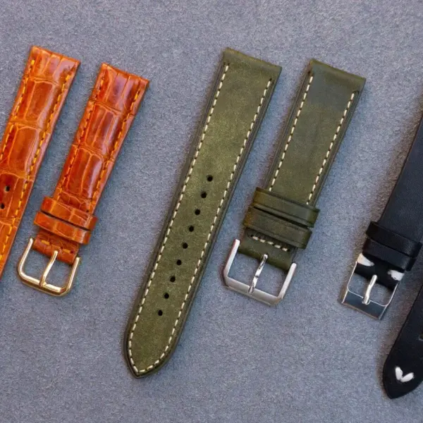 A selection of leather watch straps in various colors and styles, displayed on a textured surface, ideal for enhancing any watch for different occasions
