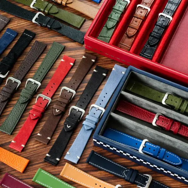 A variety of leather watch straps in different colors and styles are neatly arranged on a wooden surface, showcasing options for customization and care